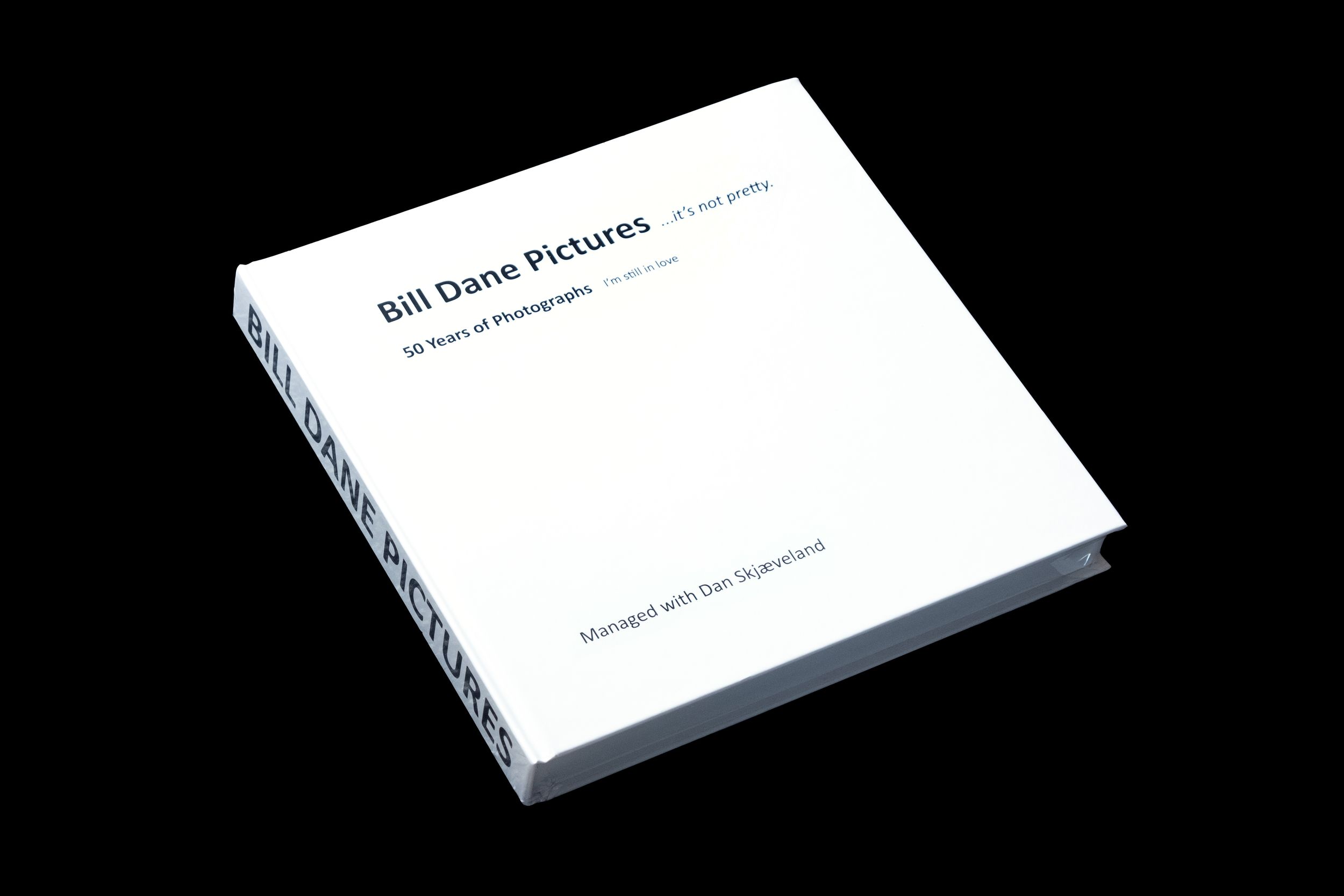 White book covers shown in progressive perspective views against black background.