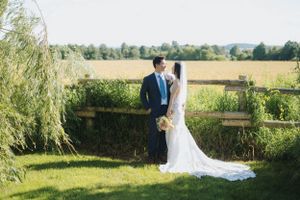 Scenic countryside wedding portraits with rolling fields in the background.