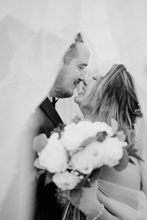 Romantic black and white close-up of a wedding couple sharing an intimate moment.