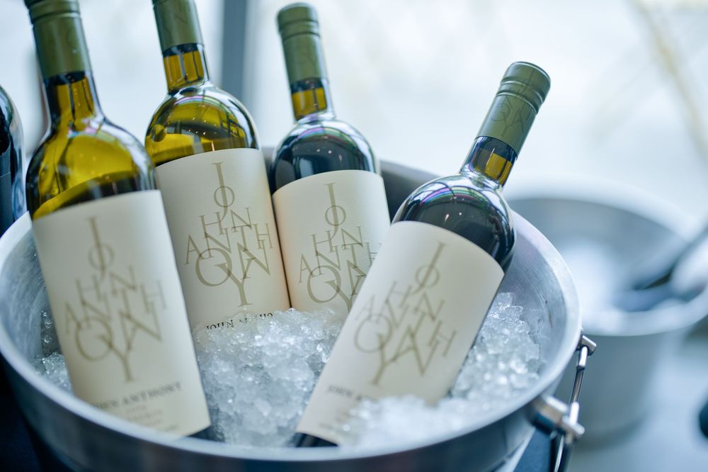 John Anthony bottles of wine chilling in an ice bucket with white and red varieties displayed at an elegant service in wine country. Napa CA