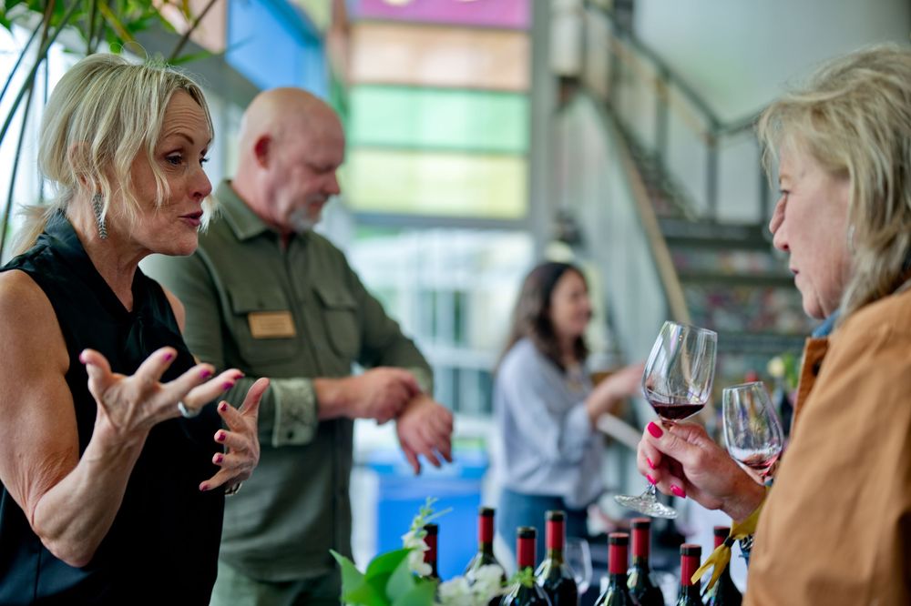 Wine tasting event at CIA Copia, Napa Valley—guests engaged in lively conversation while sampling a curated selection of fine wines.