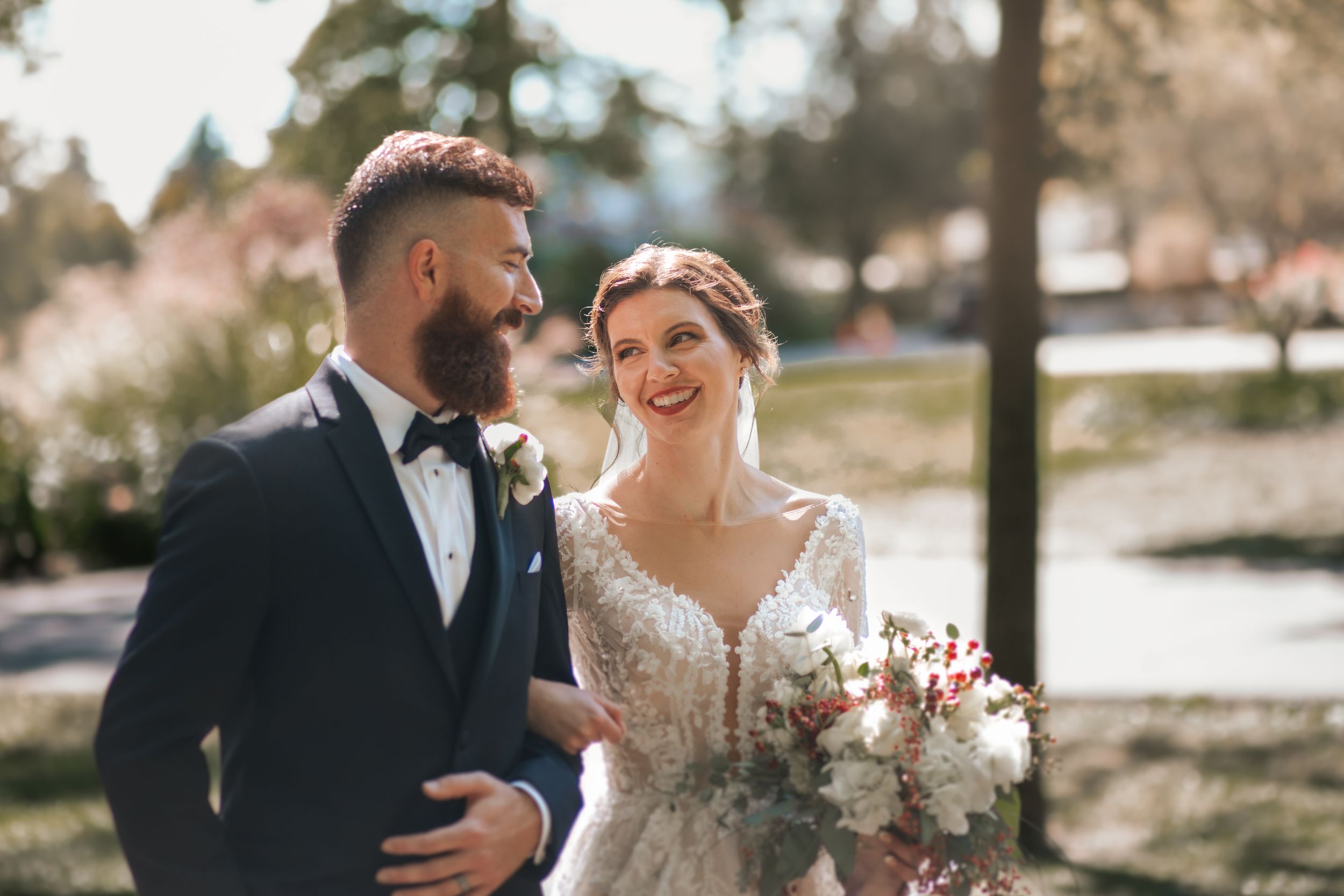 Sun-drenched wedding photos capturing candid moments between newlyweds.