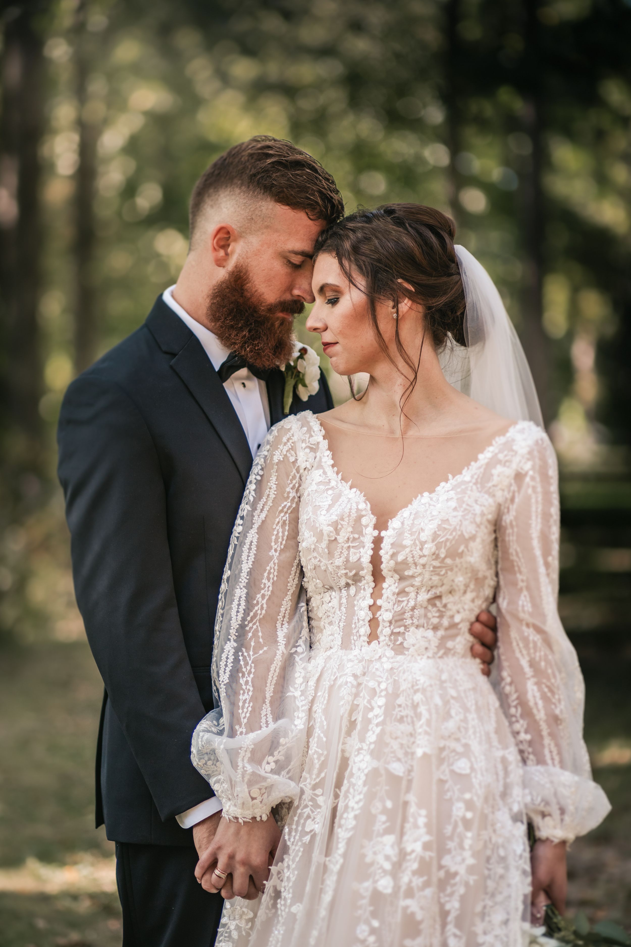 Soft focus wedding portraits showing intricate lace details of bridal gown.