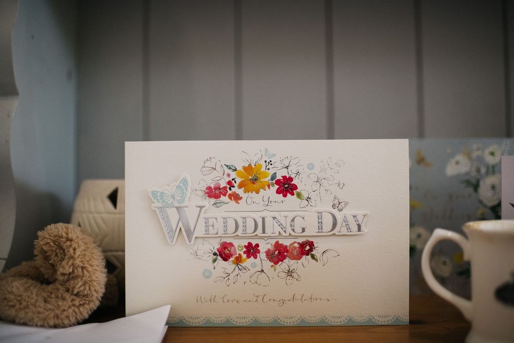 Elegant wedding day stationery and invitation cards with floral designs and calligraphy.