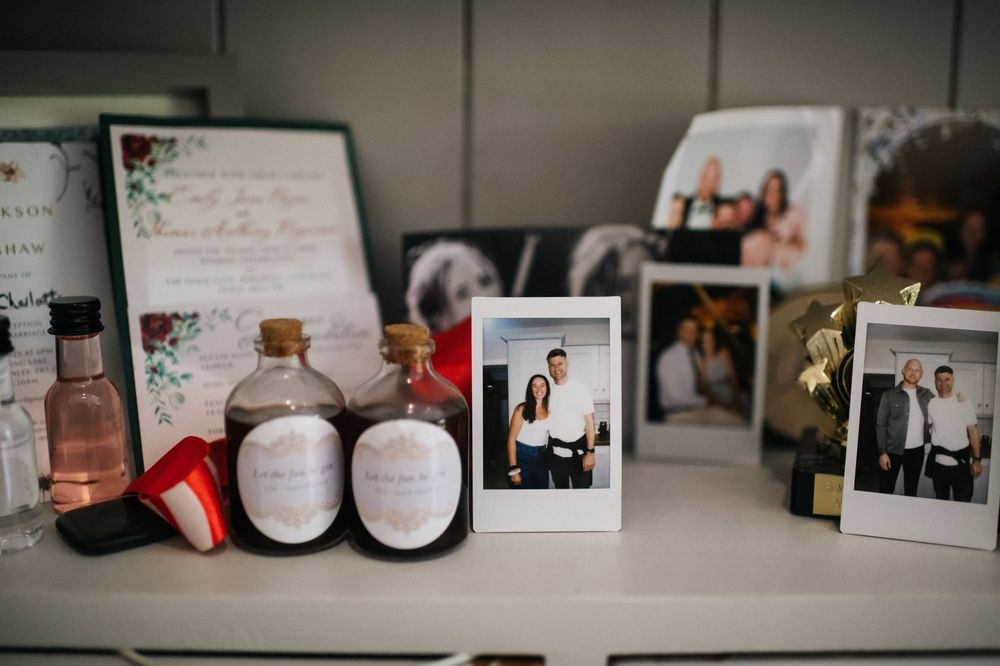 Wedding memorabilia and photos displayed on a white shelf.
