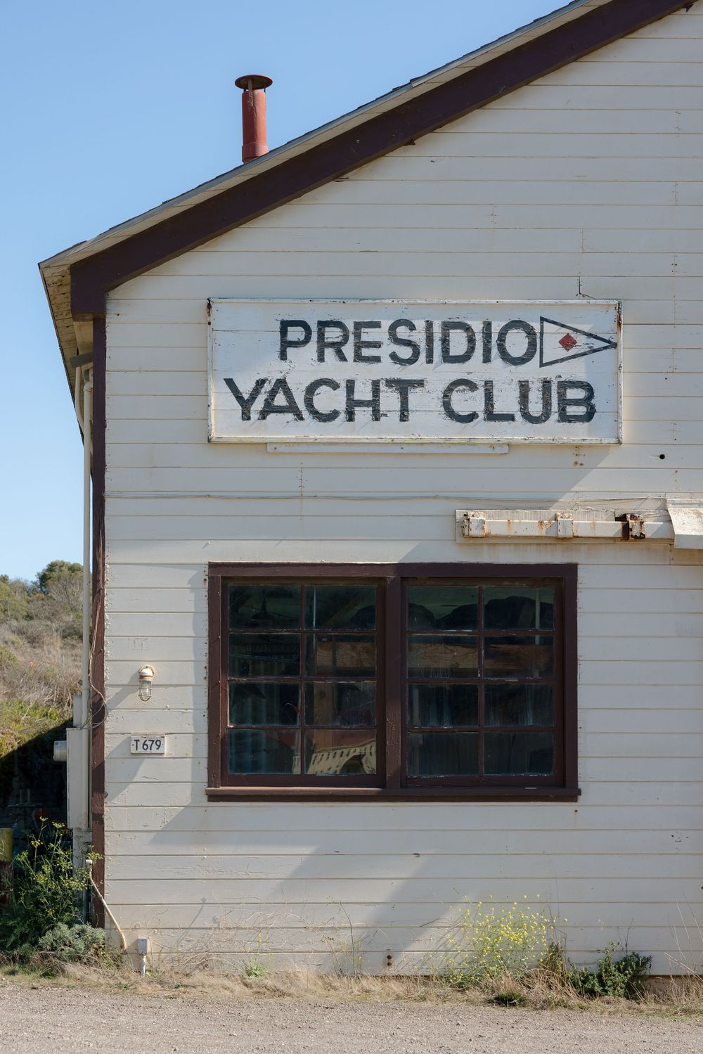 A series of exterior shots showing weathered white building walls with signs for 'Presidio' and 'Yacht Club'.