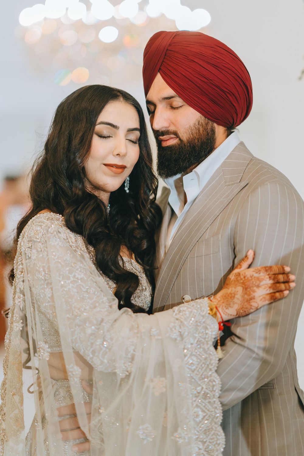 Romantic wedding photoshoot featuring traditional Sikh attire with intricate beaded details and elegant poses.