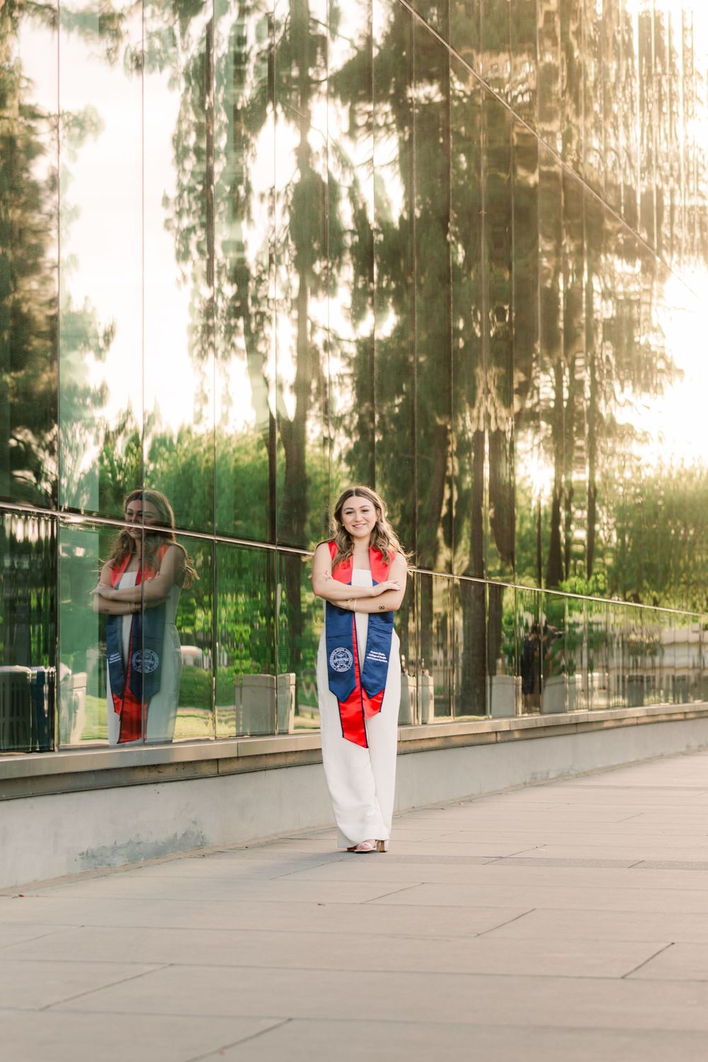A sequence of images showing someone performing a cartwheel on a concrete walkway in front of sunlit trees.