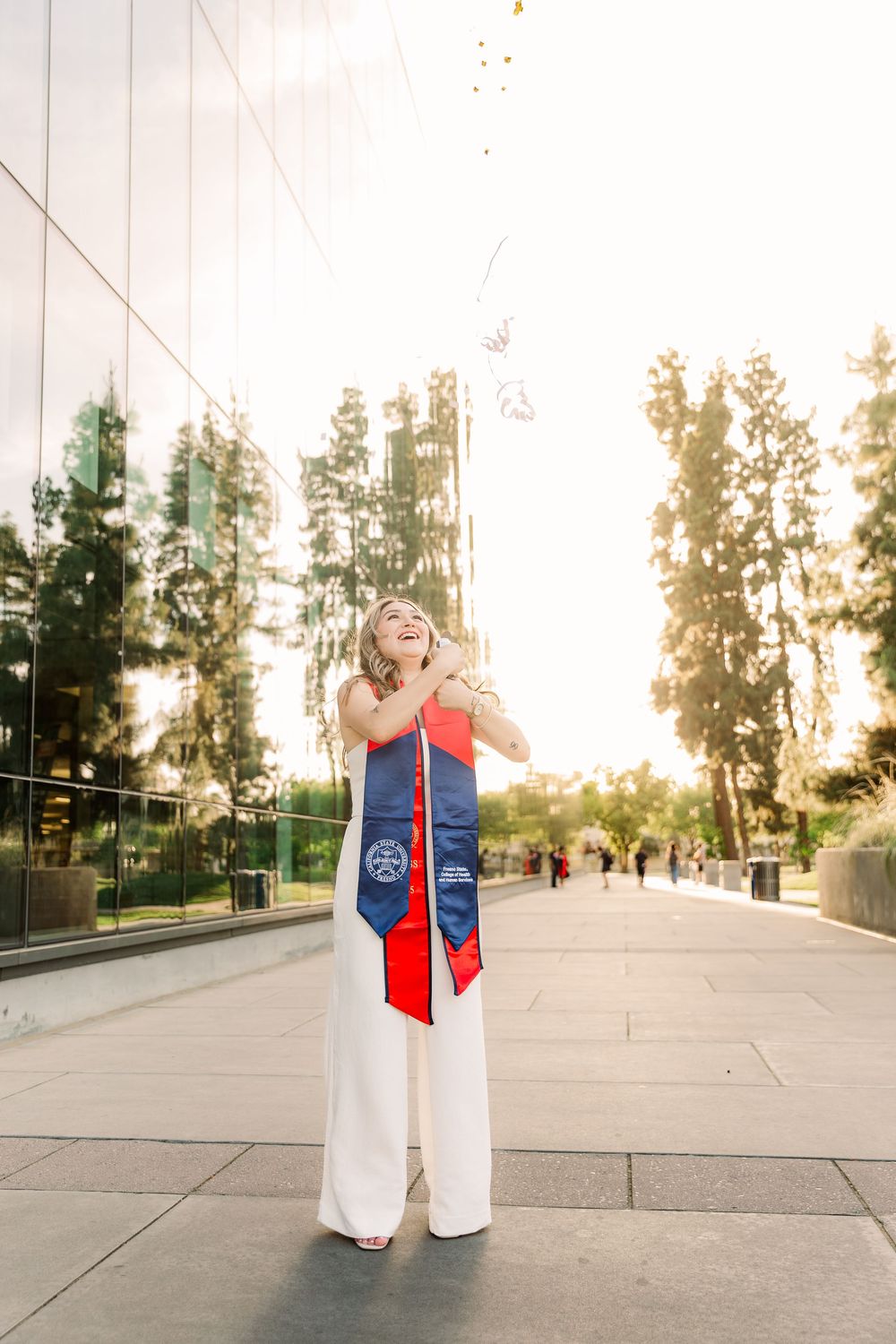A series of graduation photos showing someone in a blue and red stole celebrating against a sunset campus backdrop.