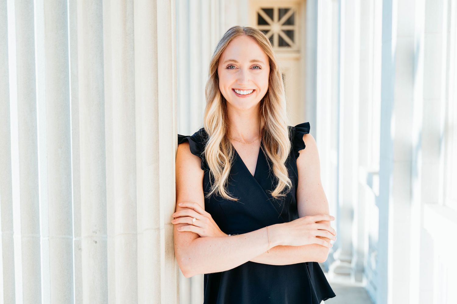 Professional headshot portraits of women in business attire against a light background.