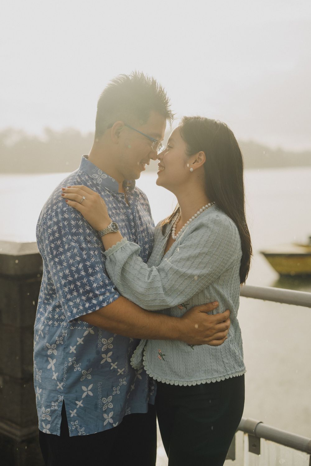 A romantic couple embraces on a misty beach at sunset, creating a series of tender moments together.