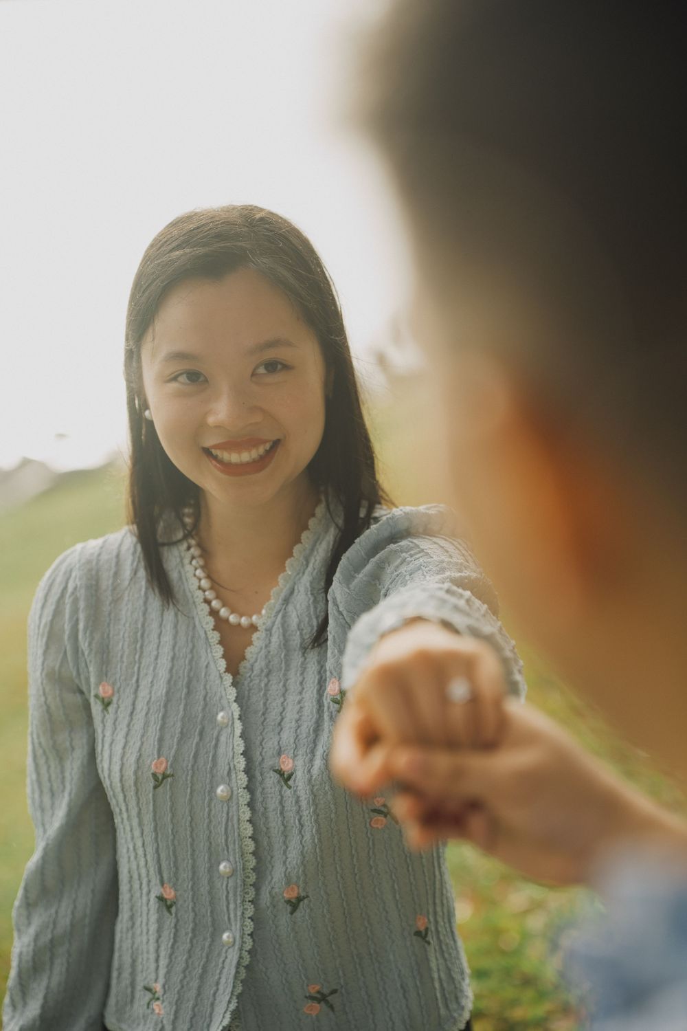 A series of candid photos showing someone in a gray sweater smiling and interacting during a conversation outdoors.
