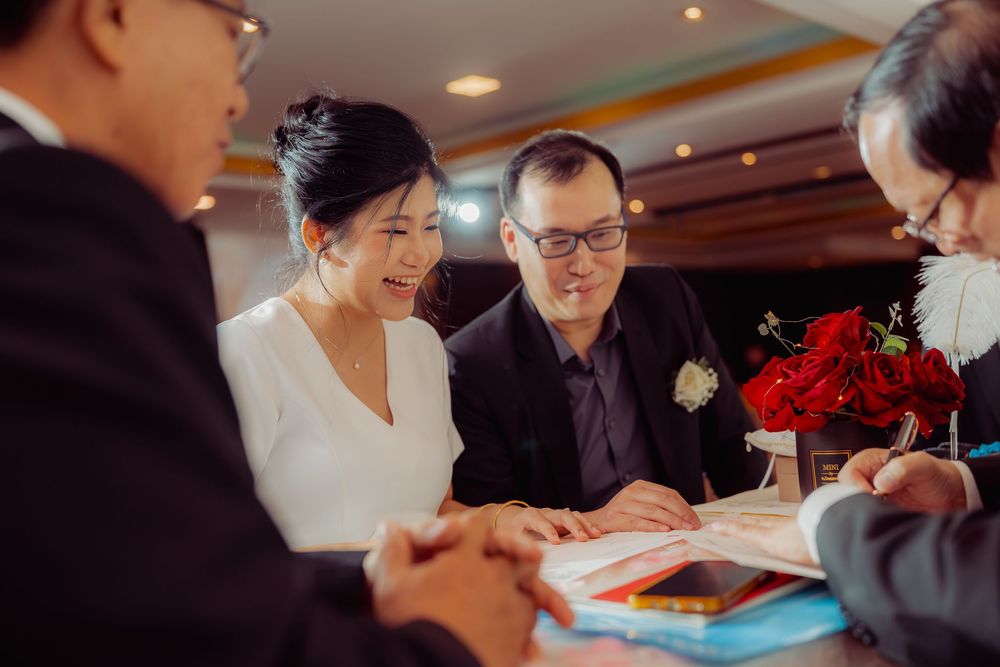 Traditional tea ceremony setup with red decorations in indoor venue.