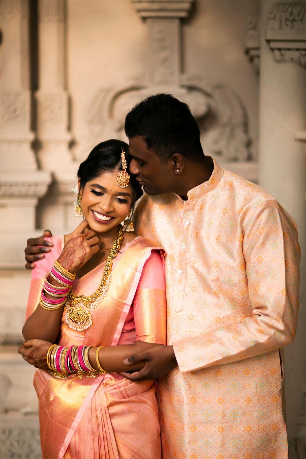 A romantic couple in traditional Indian wedding attire share intimate moments in a series of candid photos.