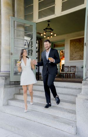 A series of candid moments showing a couple walking and laughing together on stone steps of a historic building.