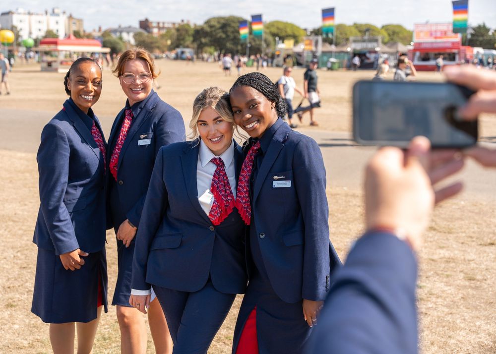 British Airways staff interacting at an outdoor event.