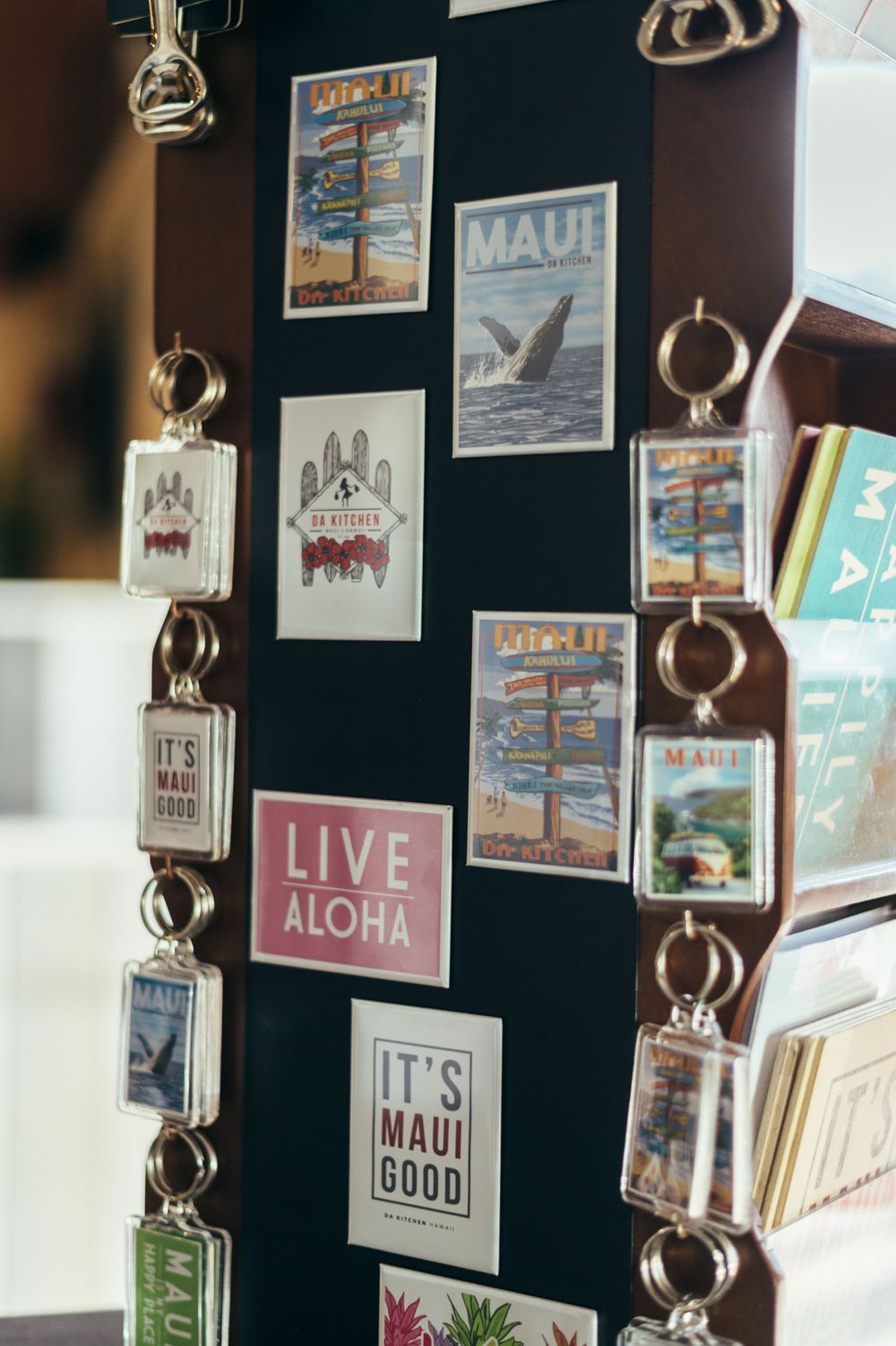 Wall display of Hawaiian-themed artwork and decorative signs including Aloha messages.