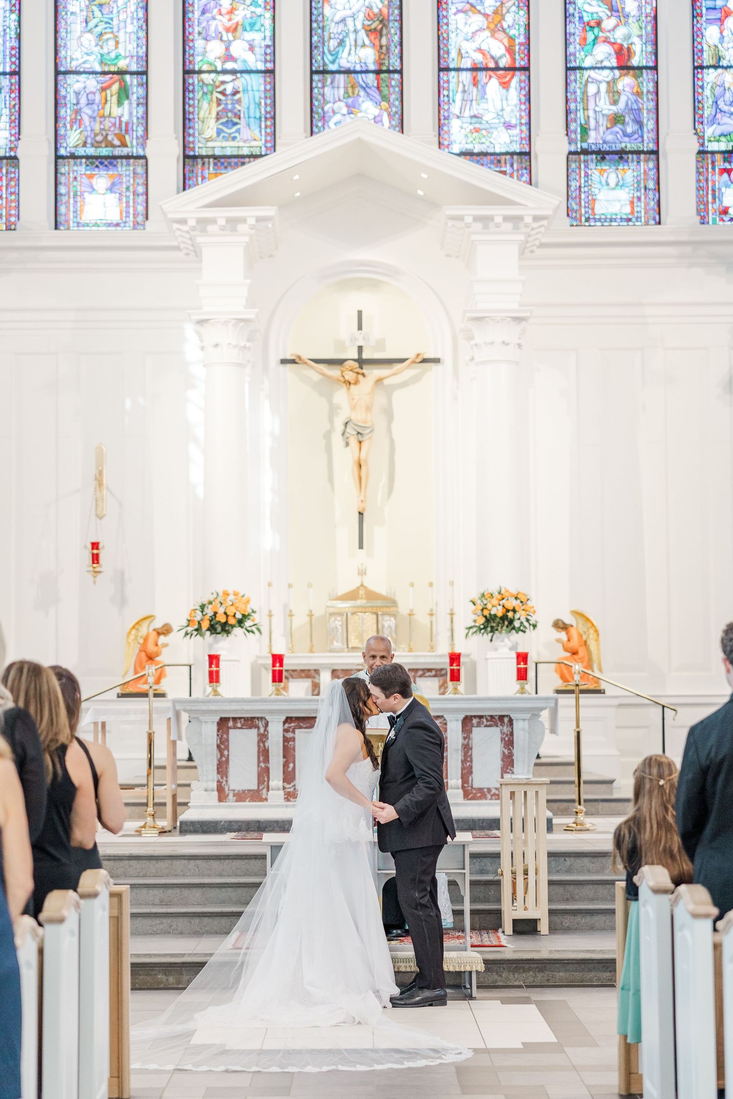 A wedding ceremony sequence in a bright church with stained glass windows and white decor.