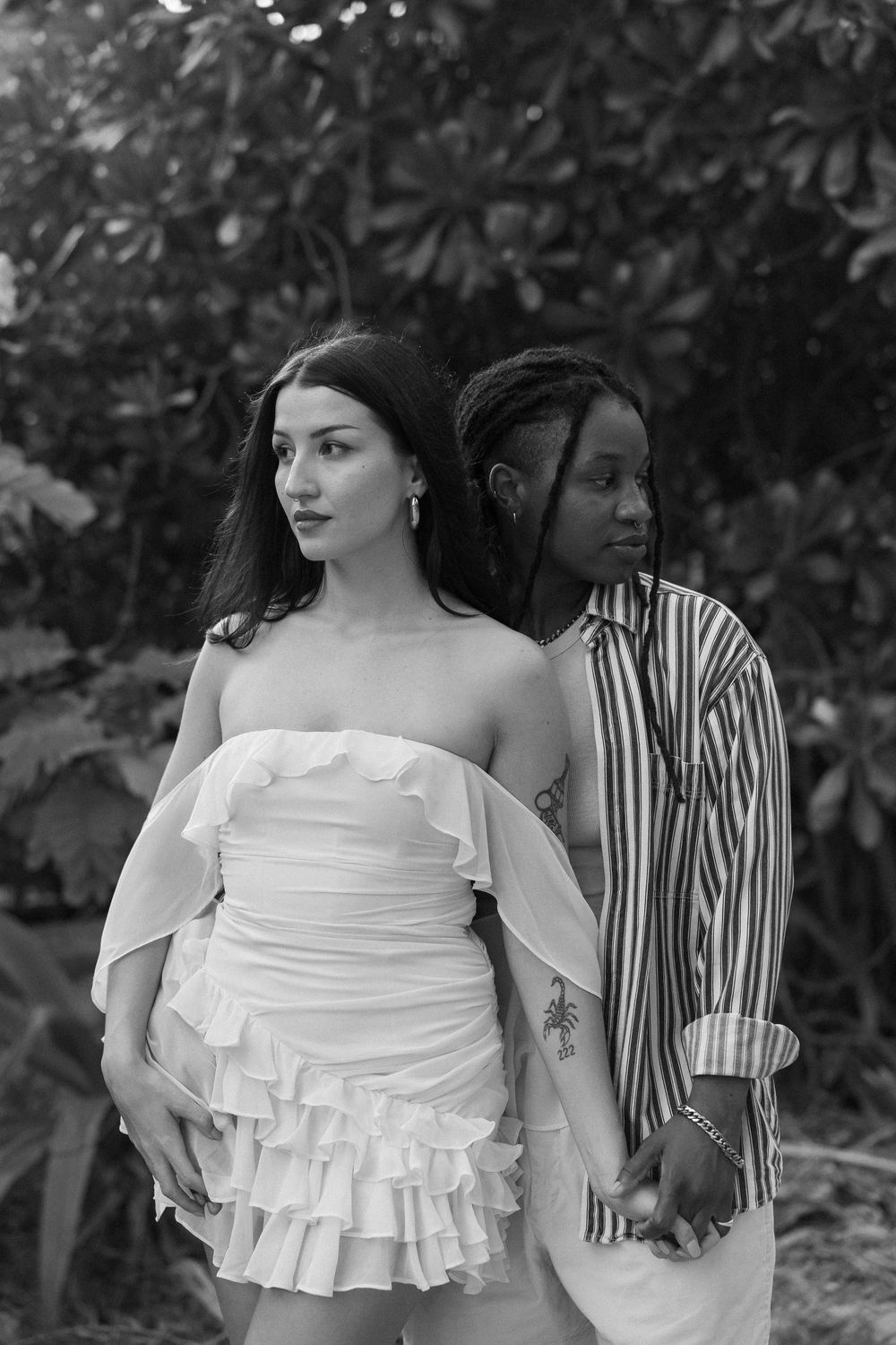 A black and white artistic photo series showing two women posing together in preparation for their proposal in Holbox