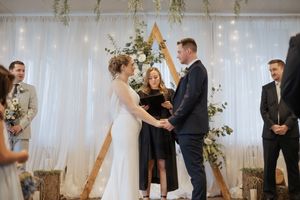 Bride and groom hold hands and exchange vows during November wedding at Spruce and Iron, Riverview NB wedding photographer, timeless photos