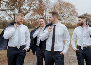 groom and groomsmen walk together in candid moment at Spruce and Iron, Moncton Golf Club winter wedding, Riverview New Brunswick photography