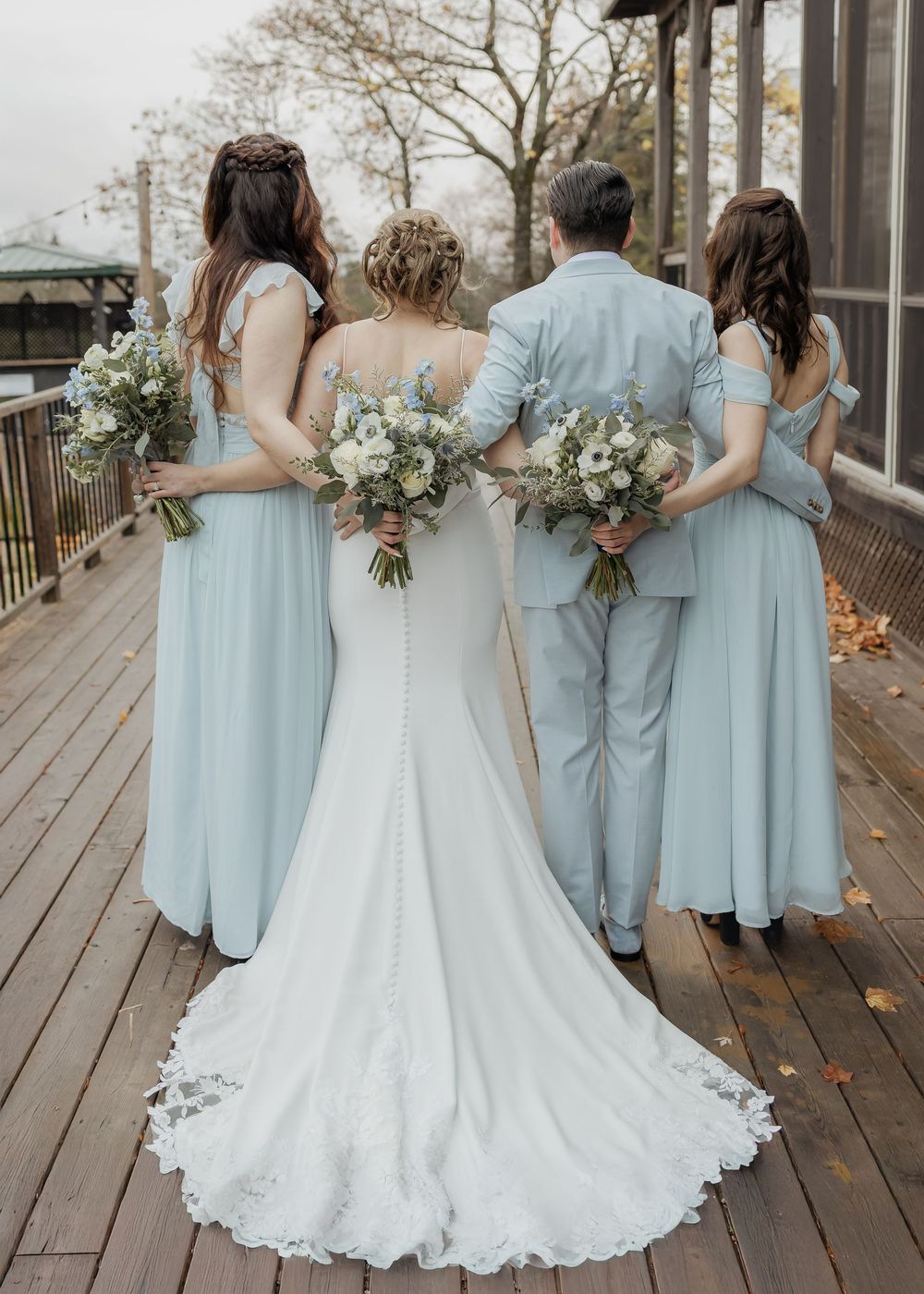 bride and bridesmaid hug during rainy November wedding at Spruce & Iron, Moncton Golf Club wedding photography, New Brunswick Canada