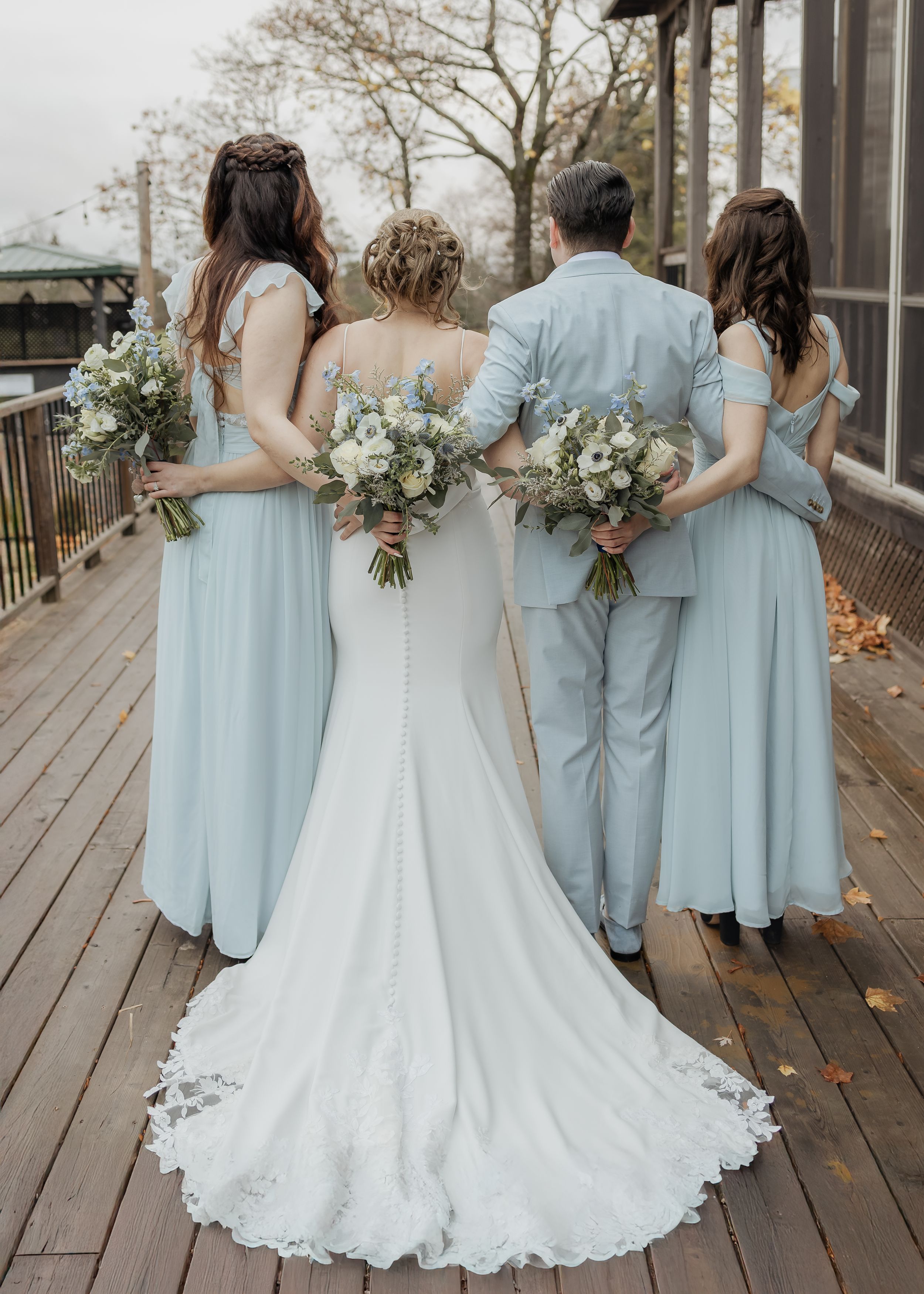 bride and bridesmaid hug during rainy November wedding at Spruce & Iron, Moncton Golf Club wedding photography, New Brunswick Canada