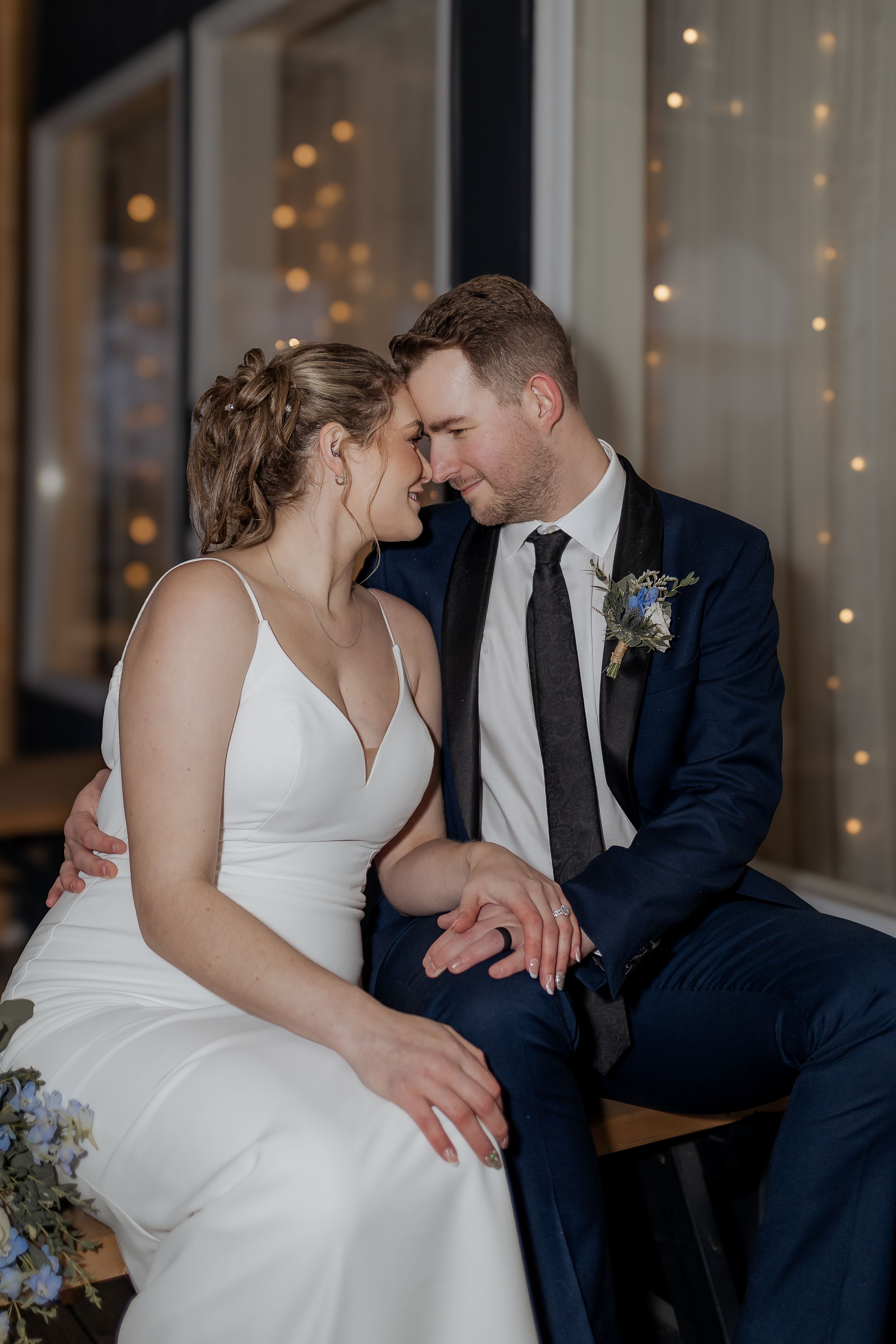 Bride and groom embrace during romantic portraits at Spruce and Iron, outdoor winter wedding, rainy November wedding in Riverview NB