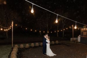 Bride and groom dance under string lights at Spruce and Iron, Moncton Golf Club winter wedding photography, flash photography outside