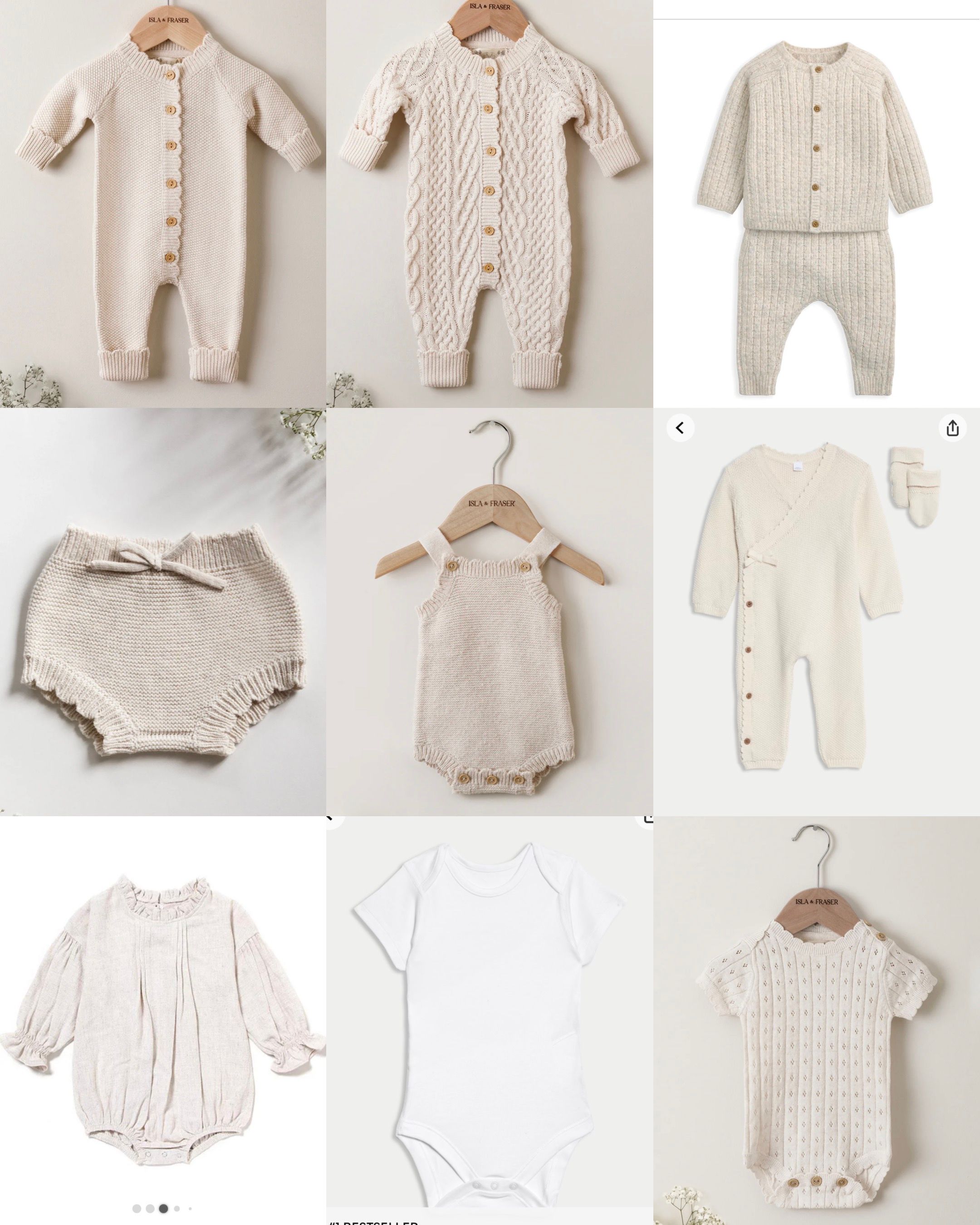Collection of neutral beige and cream colored baby rompers, onesies, and knitwear displayed on wooden hangers.