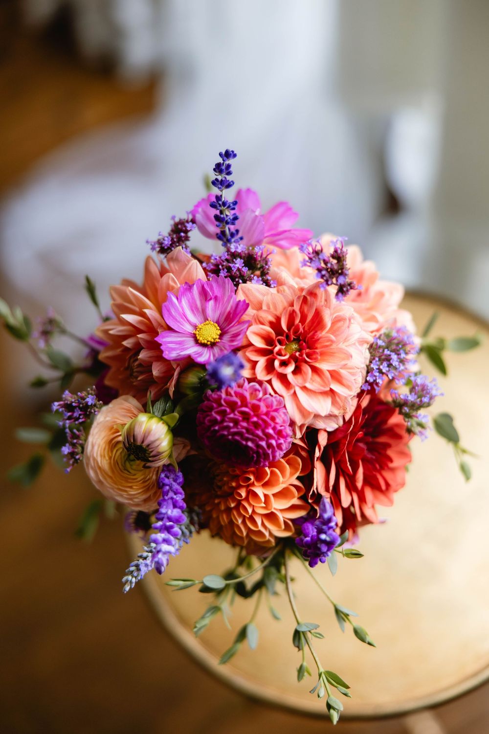 Beautiful floral arrangement with coral dahlias and purple lavender on a light surface. Appleford Estate. Villanova, PA.