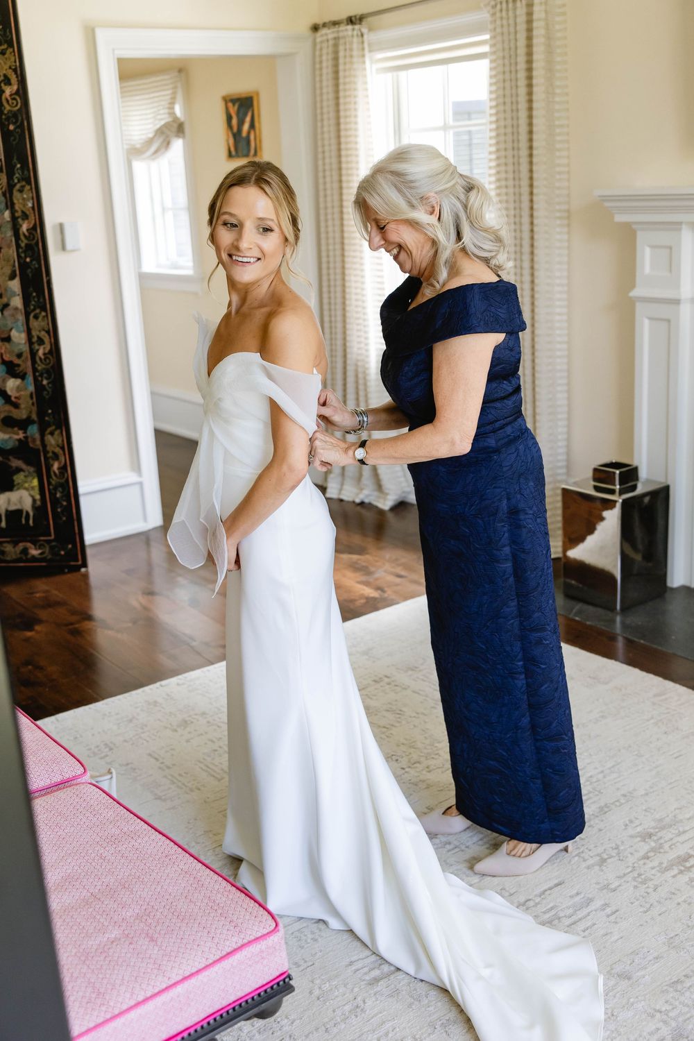 Bride in white gown getting final adjustments to dress before ceremony. Appleford Estate. Villanova, PA.