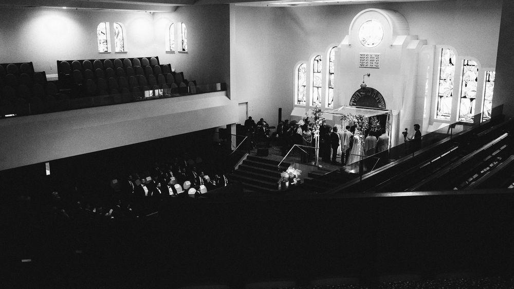 Black and white film strip showing sequential frames of an indoor architectural scene with dramatic lighting.
