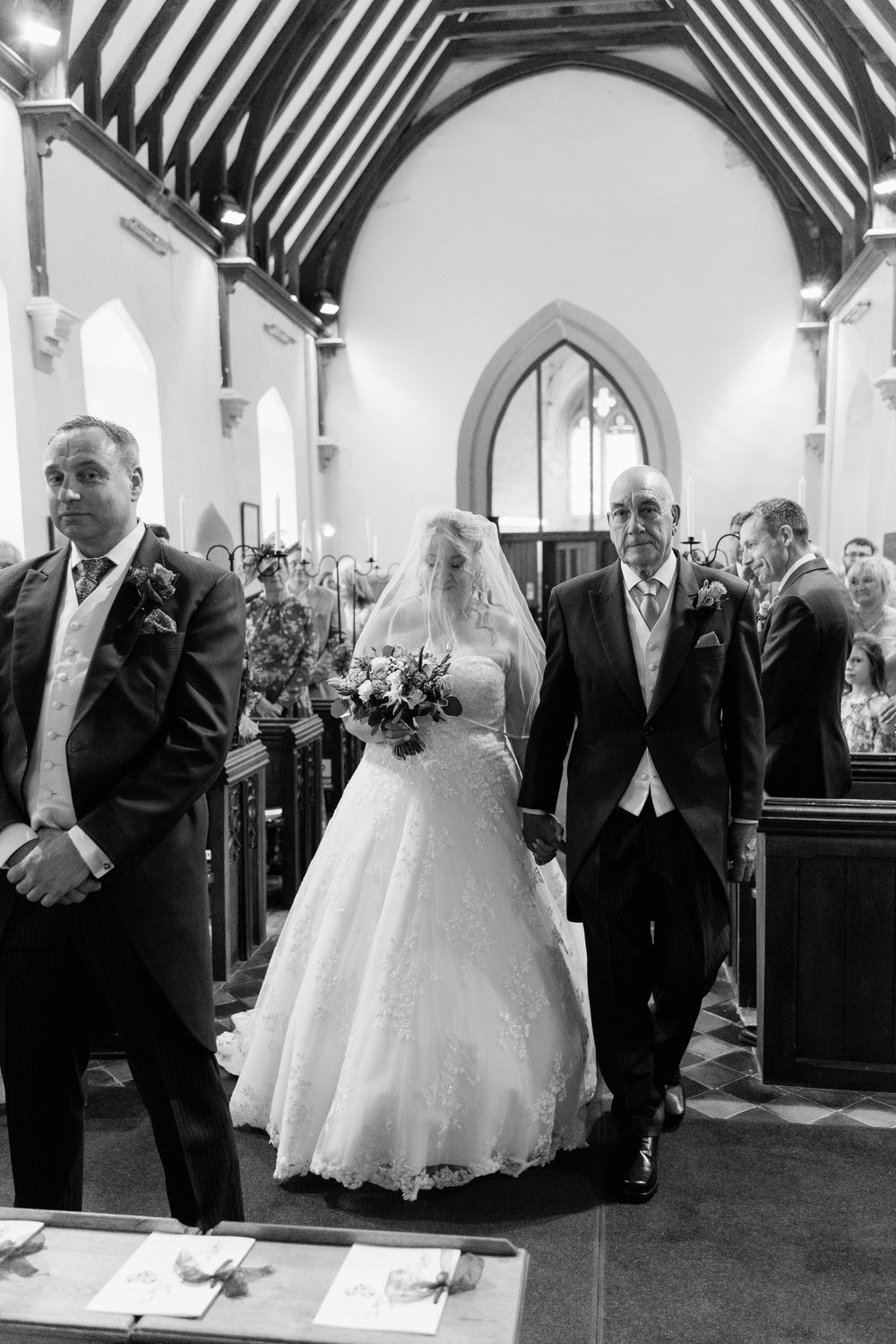 A sequence of black and white photos showing a traditional Worcestershire wedding ceremony procession in a church aisle.