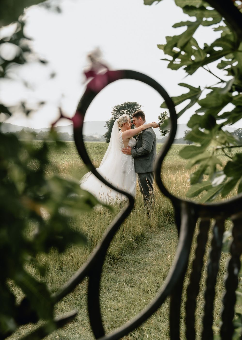 A romantic couple embraces at sunset at Birtsmorton Court, captured by Laura Jenkinson Photography