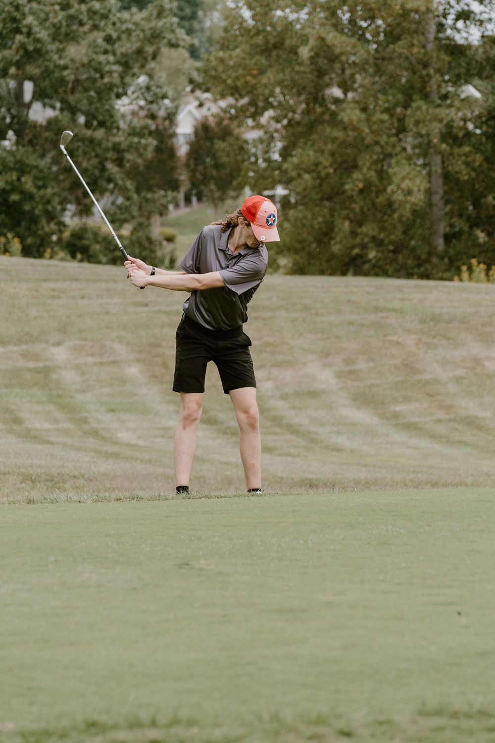 A golfer practices their putting technique on a manicured green.