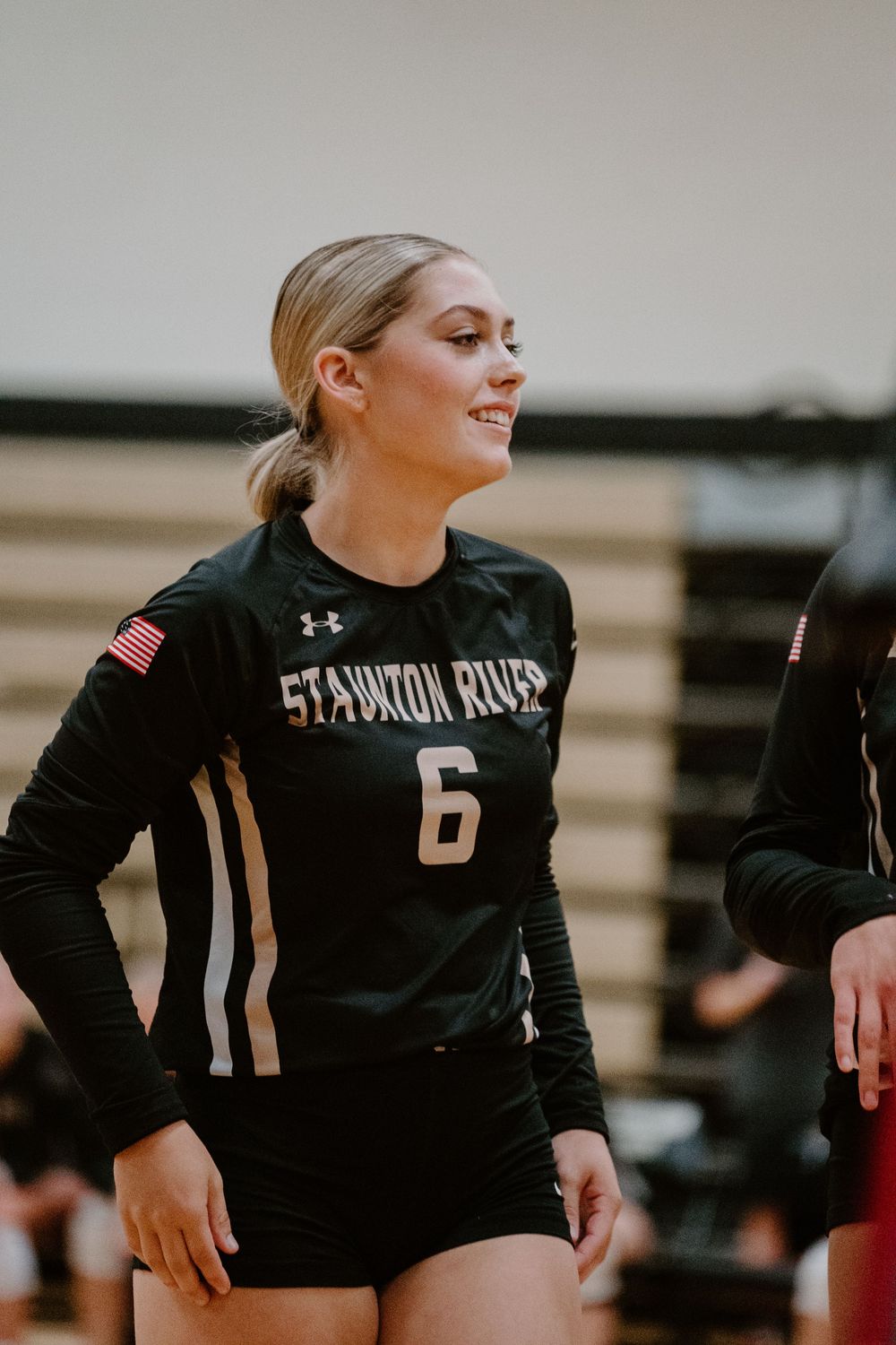 Staunton volleyball player in black uniform with number 6 stands ready during a game.