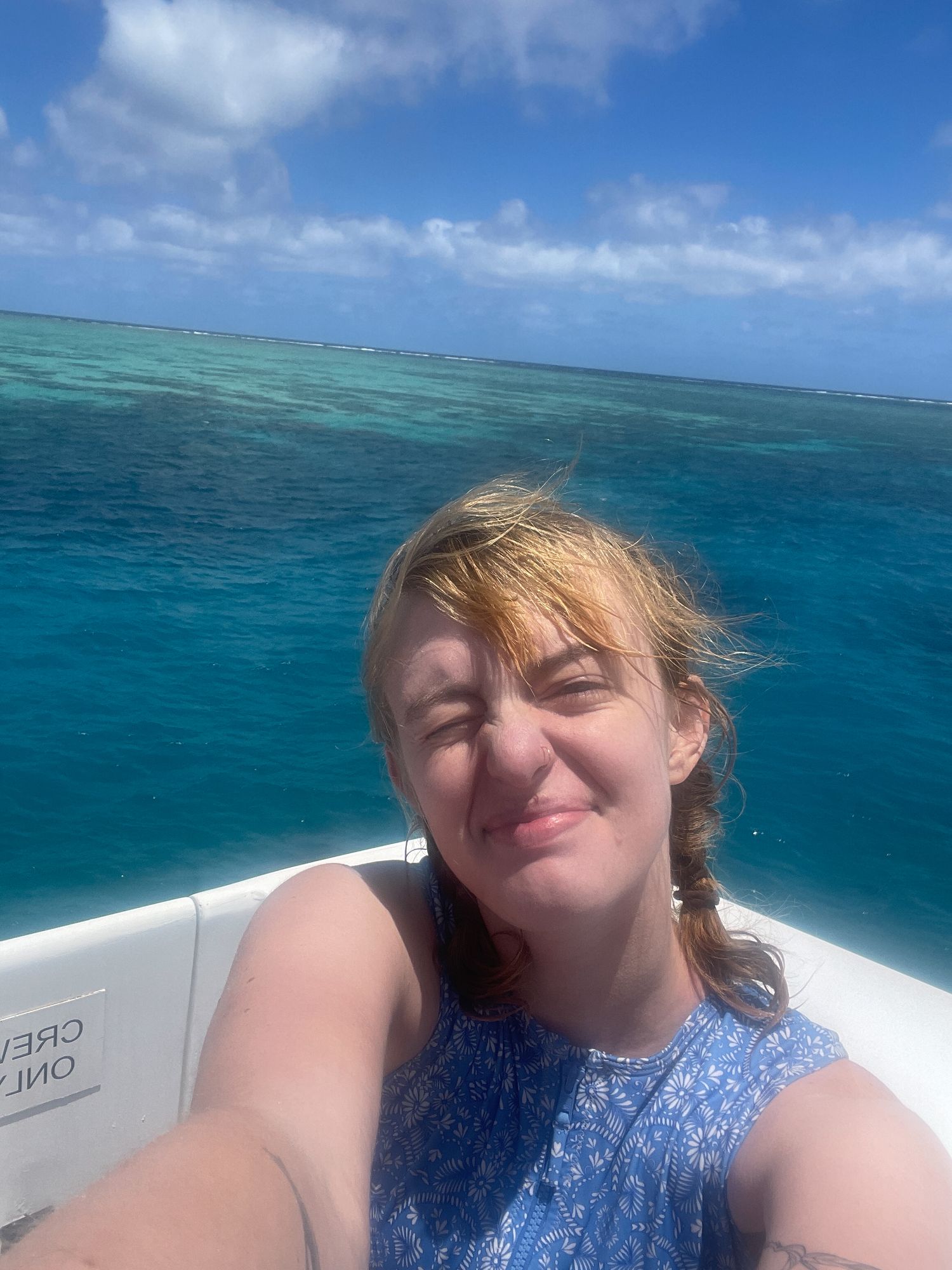 A series of selfies taken on a boat against a stunning turquoise ocean backdrop with blue skies and white clouds.