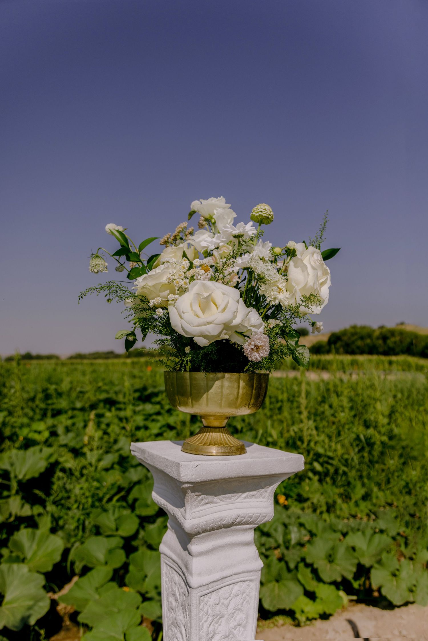 white floral arrangement in brass compote. Boise wedding florals. Milestones wedding planning, Boise wedding planner.