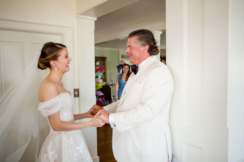 A tender moment between two people during an indoor wedding ceremony.