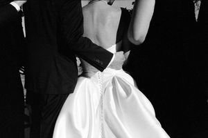 Black and white close-up of bride and groom sharing their first dance at wedding reception.