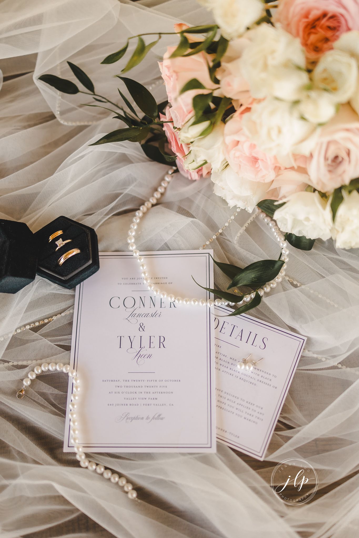 Wedding invitations and details styled with pink roses, pearls, and delicate tulle fabric.
