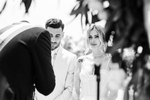 Black and white candid wedding moments showing emotional reactions.