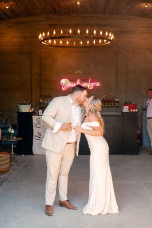 Romantic dance scene under warm chandelier lighting in an indoor reception venue.