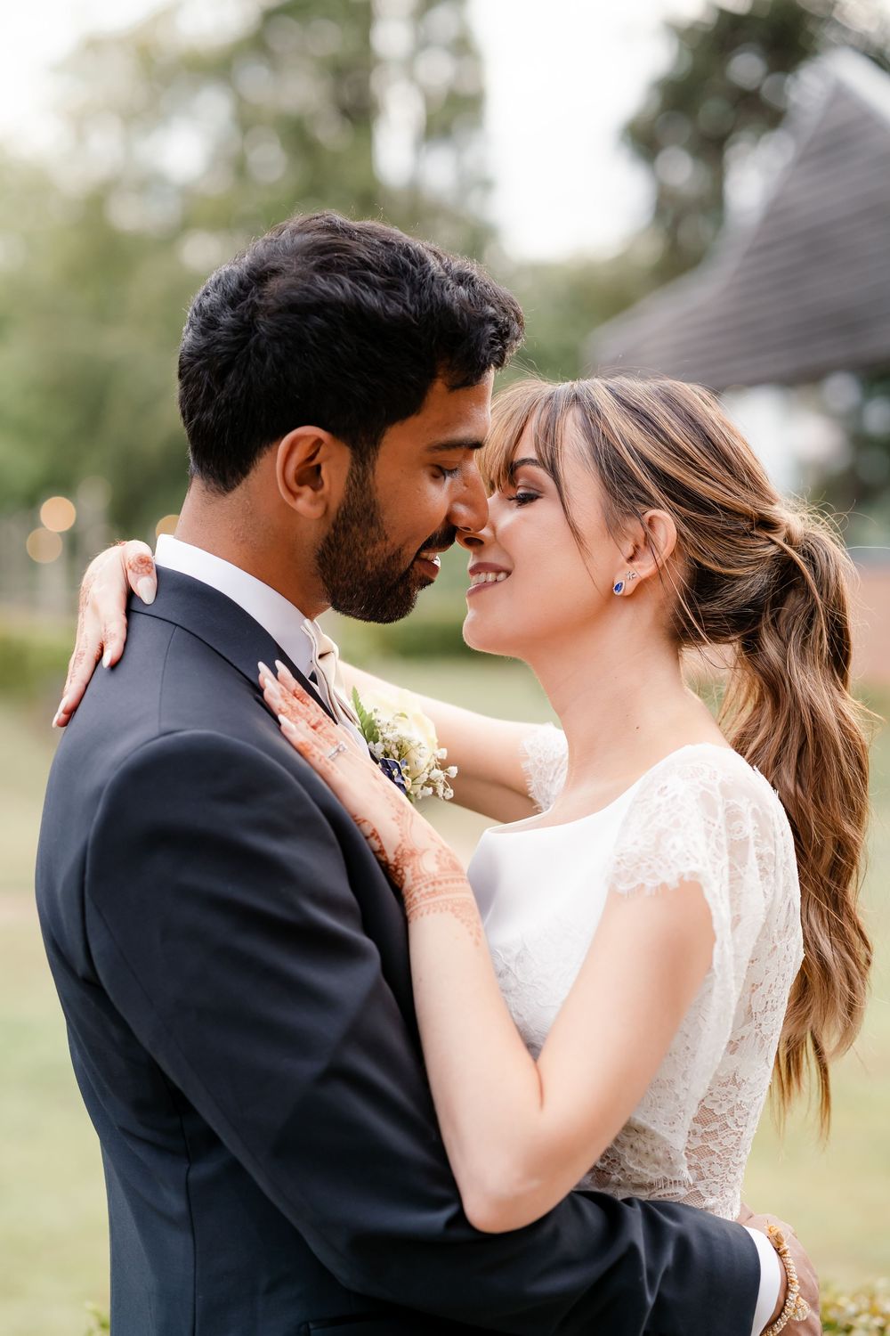 First look in British wedding outfits — bride in Pronovias gown, groom in tuxedo, fusion wedding photography