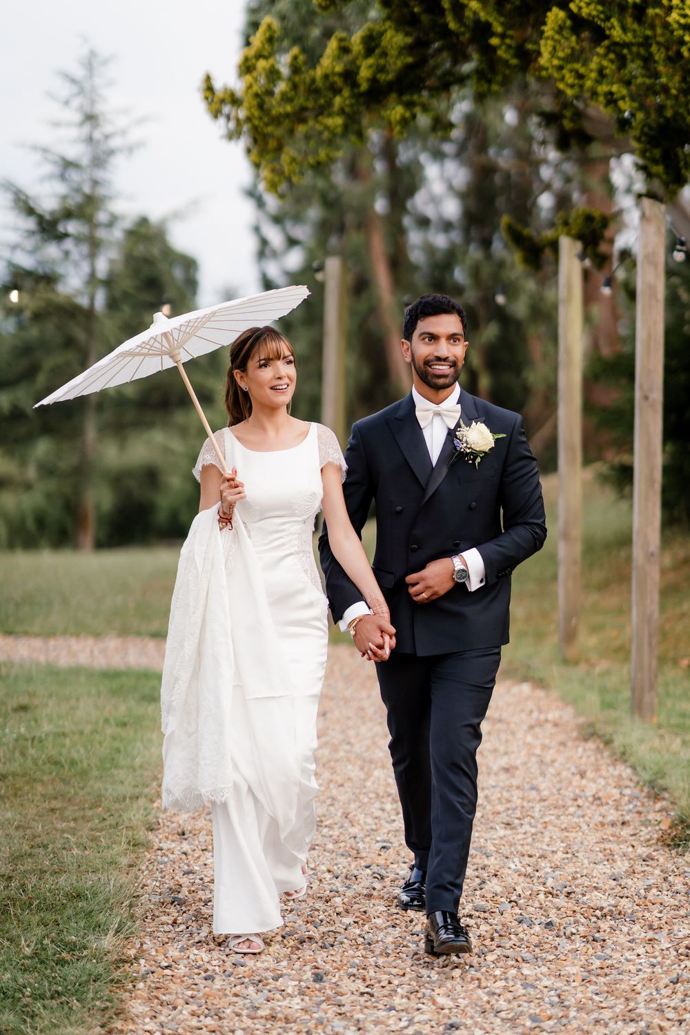 First look in British wedding outfits — bride in Pronovias gown, groom in tuxedo, fusion wedding photography