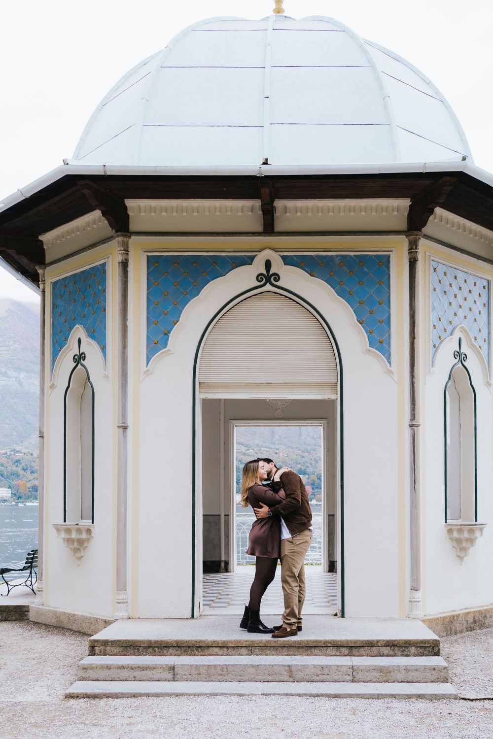 Multiple views of a couple's special moment in a white lakeside gazebo with Gothic-style arched windows.