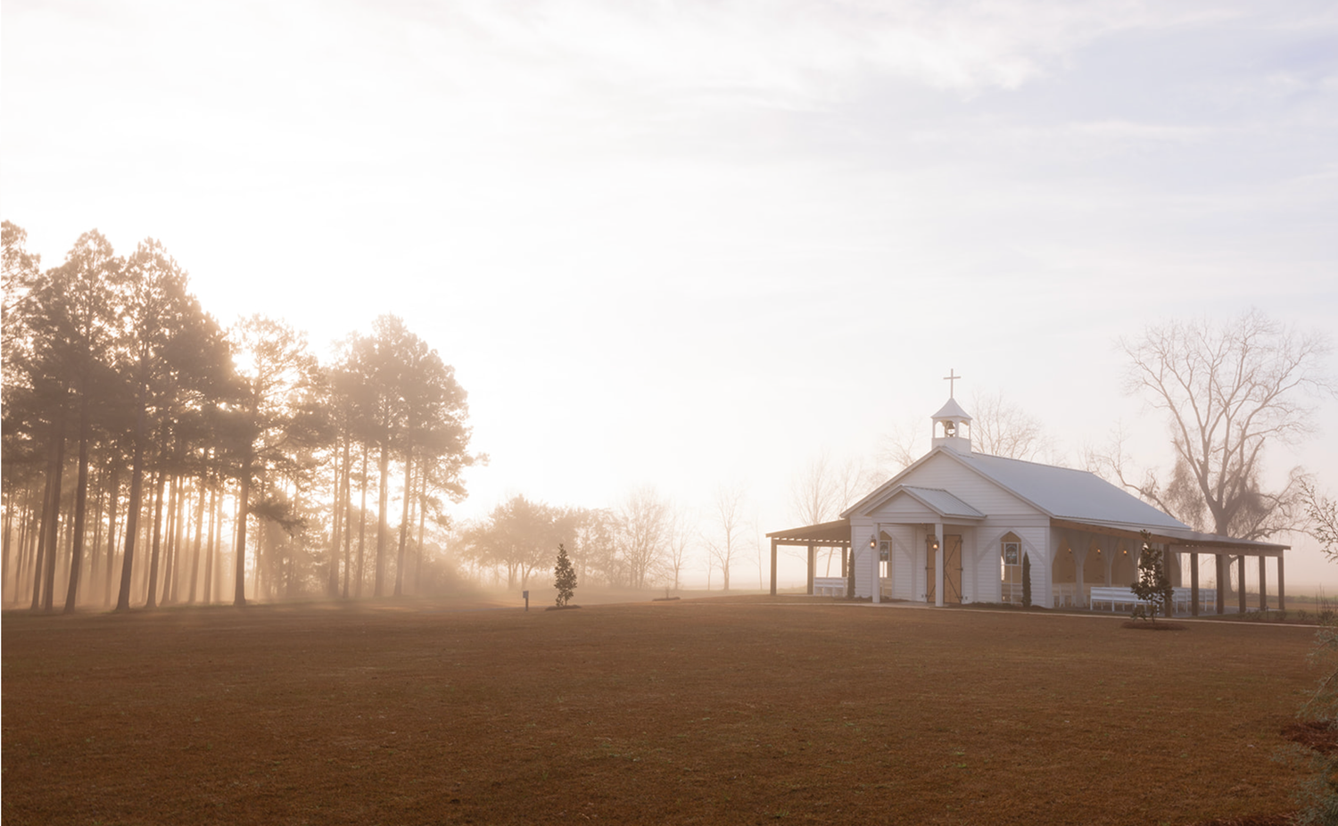 Sunset at Collins Place wedding venue in Cairo, Georgia with trees and rustic barn setting