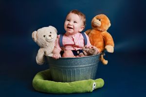 Small child sits in metal tub Carlsbad Roswell Artesia Hobbs New Mexico NM Photography Maternity Milestones Newborn Pictures.