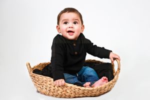 A young child wearing a black sweater Carlsbad, Roswell, Artesia, Hobbs New Mexico NM Photography Maternity, Milestones, Newborn Pictures